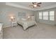Spacious main bedroom features a tray ceiling, ceiling fan, and sitting area by the windows at 5111 Olive Branch Cir, Powder Springs, GA 30127