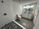 Modern bathroom with dual sinks, granite counters, walk-in tile shower, and stylish fixtures at 517 Whitley Dr, Forest Park, GA 30297