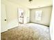 Bedroom with neutral carpet adjoins a bathroom with dual sinks and updated fixtures at 517 Whitley Dr, Forest Park, GA 30297