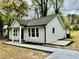 Exterior view of a light blue home showing fresh landscaping, new concrete walkway, and well-maintained surroundings at 517 Whitley Dr, Forest Park, GA 30297