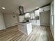 Bright kitchen featuring white cabinets, granite countertops, stainless steel appliances, and a central island at 517 Whitley Dr, Forest Park, GA 30297