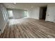 Spacious living room with wood-look flooring, abundant natural light, and fresh paint at 517 Whitley Dr, Forest Park, GA 30297