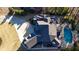 Aerial view of a luxury home featuring a pristine pool, a jacuzzi, and lush landscaping creating a private and elegant retreat at 6925 Lighthouse Point, Cumming, GA 30041
