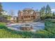 Spacious backyard with stone fire pit and lush landscaping, perfect for entertaining at 6925 Lighthouse Point, Cumming, GA 30041