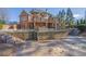 Large stone retaining wall with tiered steps leading to the home's beautiful in-ground pool at 6925 Lighthouse Point, Cumming, GA 30041