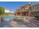A pool and hot tub sit next to a brick house with multiple balconies and a covered patio at 6925 Lighthouse Point, Cumming, GA 30041