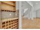 Wet bar with wine storage, granite countertop, custom wood cabinetry, and hardwood floors at 6925 Lighthouse Point, Cumming, GA 30041