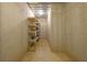 Unfinished basement with concrete walls and floors, ready for customization with shelving for storage, offering potential living space at 6925 Lighthouse Point, Cumming, GA 30041