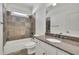 Bathroom featuring tile walls, a bathtub, and a granite countertop at 6925 Lighthouse Point, Cumming, GA 30041
