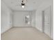 Spacious bedroom with neutral carpet, white trim and ceiling fan at 6925 Lighthouse Point, Cumming, GA 30041