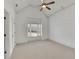 Bedroom with neutral carpet, a ceiling fan, a window for natural light, and white trim at 6925 Lighthouse Point, Cumming, GA 30041