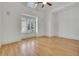 Bright bedroom with hardwood floors and a large window offering natural light and a view of the outdoors at 6925 Lighthouse Point, Cumming, GA 30041