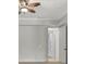 Bedroom with neutral walls, ceiling fan, door to en suite, and partial view of transom windows at 6925 Lighthouse Point, Cumming, GA 30041