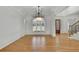 Elegant dining room featuring hardwood floors, detailed trim and large windows for ample light at 6925 Lighthouse Point, Cumming, GA 30041