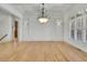 Bright dining room featuring hardwood floors, decorative lighting and large windows for natural light at 6925 Lighthouse Point, Cumming, GA 30041