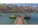 Beautiful view of a covered boat dock featuring boat lifts and a staircase to the roof at 6925 Lighthouse Point, Cumming, GA 30041
