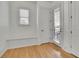 Mudroom featuring hardwood floors, built in bench, and a window at 6925 Lighthouse Point, Cumming, GA 30041