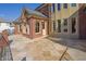 Rear exterior featuring a stone patio, brick facade, and plenty of windows at 6925 Lighthouse Point, Cumming, GA 30041