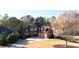 Elegant brick home with manicured landscaping, a circular driveway, and a three-car garage creating stunning curb appeal at 6925 Lighthouse Point, Cumming, GA 30041