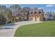 Beautiful brick home boasts a three-car garage and a lush green lawn, perfect for outdoor enjoyment at 6925 Lighthouse Point, Cumming, GA 30041