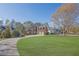 Beautiful brick home boasts a three-car garage and a lush green lawn, perfect for outdoor enjoyment at 6925 Lighthouse Point, Cumming, GA 30041