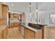 Spacious kitchen featuring hardwood floors, an island with granite countertops and stainless steel appliances at 6925 Lighthouse Point, Cumming, GA 30041