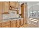 Gourmet kitchen featuring custom wood cabinetry, granite countertops, and stainless steel appliances at 6925 Lighthouse Point, Cumming, GA 30041