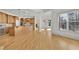 Open concept kitchen and living area featuring hardwood floors, an island, and lots of natural light at 6925 Lighthouse Point, Cumming, GA 30041