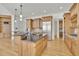 Open concept kitchen with large island, custom cabinets, stainless appliances, and hardwood floors at 6925 Lighthouse Point, Cumming, GA 30041