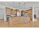 Gourmet kitchen featuring hardwood floors, custom cabinets and a kitchen island with bar seating at 6925 Lighthouse Point, Cumming, GA 30041