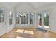 Bright living room featuring hardwood floors, clerestory windows, French doors, and detailed trim at 6925 Lighthouse Point, Cumming, GA 30041