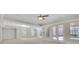 Spacious living room with ample natural light, tray ceiling, and neutral paint at 6925 Lighthouse Point, Cumming, GA 30041