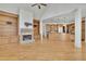 Open concept living room featuring hardwood floors, a stone fireplace and an island with bar seating at 6925 Lighthouse Point, Cumming, GA 30041