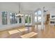 Sun-filled living room featuring hardwood floors, fireplace, built-in shelves and clerestory windows at 6925 Lighthouse Point, Cumming, GA 30041