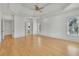 Spacious main bedroom featuring hardwood floors, recessed lighting, and a tray ceiling with ceiling fan at 6925 Lighthouse Point, Cumming, GA 30041