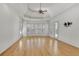 Spacious main bedroom featuring hardwood floors, recessed lighting, and a bay window, with access to a porch at 6925 Lighthouse Point, Cumming, GA 30041