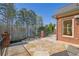 Beautiful patio with brick columns, and a view of a lake surrounded by mature trees at 6925 Lighthouse Point, Cumming, GA 30041