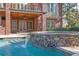 Beautiful pool with stone accents and waterfall feature, perfect for relaxing and entertaining in a luxurious outdoor space at 6925 Lighthouse Point, Cumming, GA 30041