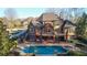 Spacious brick home featuring a pool, jacuzzi, and balcony with views of the surrounding landscape, ideal for outdoor living at 6925 Lighthouse Point, Cumming, GA 30041