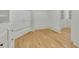 Spacious walk-in closet with custom shelving and storage, plus wood flooring at 6925 Lighthouse Point, Cumming, GA 30041