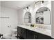 Elegant bathroom featuring a double sink vanity, marble counters, and arched mirrors at 1500 Tara Pl # 709, Hampton, GA 30228
