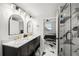 Stunning bathroom features marble counters, gold fixtures, black cabinets, and a glass shower with marble tile at 1500 Tara Pl # 709, Hampton, GA 30228