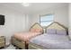 This bedroom offers a dazzling chandelier, two beds, and neutral paint and trim for a peaceful ambiance at 1500 Tara Pl # 709, Hampton, GA 30228