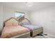 This bedroom features two beds, a large window, and stylish chandelier for a comfortable and appealing space at 1500 Tara Pl # 709, Hampton, GA 30228