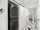 Hallway with stackable washer/dryer and ample closet space provides functional, stylish living at 1500 Tara Pl # 709, Hampton, GA 30228