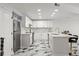 Bright kitchen featuring stainless steel appliances, marble countertops, and white cabinetry at 1500 Tara Pl # 709, Hampton, GA 30228