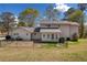 Back of house with chain link fence, porch and lawn at 300 Smith Ave, Bowdon, GA 30108