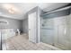 Bathroom featuring a glass shower, soaking tub, and tile floors at 300 Smith Ave, Bowdon, GA 30108