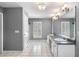 Bathroom with double vanity, tile floors, large mirror, and modern lighting at 300 Smith Ave, Bowdon, GA 30108
