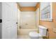 Bathroom with a standard shower-tub, tile floors, and a toilet at 300 Smith Ave, Bowdon, GA 30108